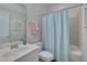 Functional bathroom featuring a vanity, toilet and bathtub with a stylish shower curtain at 2411 Lynch Store Rd, Mebane, NC 27302