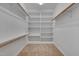 Well-organized walk-in closet featuring multiple shelves and rods to keep your wardrobe organized and accessible at 2411 Lynch Store Rd, Mebane, NC 27302