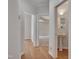 Inviting hallway leading to various rooms, featuring hardwood floors and a convenient pedestal sink at 2411 Lynch Store Rd, Mebane, NC 27302