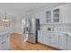 This kitchen includes stainless steel appliances, white cabinets and an eat-in island at 2411 Lynch Store Rd, Mebane, NC 27302