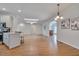 Bright open-concept living room with skylights, chandelier lighting and views into the kitchen at 2411 Lynch Store Rd, Mebane, NC 27302