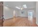 Spacious living room featuring hardwood floors, skylights, and an open layout for comfortable and modern living at 2411 Lynch Store Rd, Mebane, NC 27302