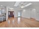 Bright living room with hardwood floors, skylights, open floorplan, and a view of the kitchen area at 2411 Lynch Store Rd, Mebane, NC 27302