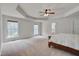 Spacious primary bedroom with carpet flooring, a ceiling fan, and two large windows for ample natural light at 2411 Lynch Store Rd, Mebane, NC 27302