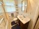 Bright bathroom featuring a single sink vanity, toilet, shower/tub, and window at 2501 Landis Dr, Durham, NC 27705