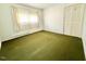 Bedroom with ample natural light, featuring a plush carpet and closet storage at 2501 Landis Dr, Durham, NC 27705
