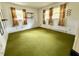 Spacious bedroom featuring multiple windows, neutral walls, and plush carpeting at 2501 Landis Dr, Durham, NC 27705