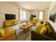 Bright living room with large windows, comfortable seating, and stylish mid-century modern decor at 2501 Landis Dr, Durham, NC 27705