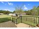 View of backyard and other buildings from a wood deck with black railings at 2651 Bennett Rd, Creedmoor, NC 27522