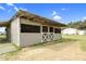 Barn with gray siding, white crossbuck doors, and a tin roof sits on a grassy lot at 2651 Bennett Rd, Creedmoor, NC 27522
