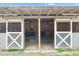 Empty barn stalls showing the wood interior and crossbuck door at 2651 Bennett Rd, Creedmoor, NC 27522