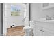 Bright bathroom featuring wood flooring, a window with natural light, toilet and white vanity at 2651 Bennett Rd, Creedmoor, NC 27522