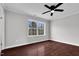 Empty bedroom features neutral walls, a ceiling fan, a window, and dark wood-look floors at 2651 Bennett Rd, Creedmoor, NC 27522