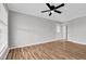 Bright bedroom with hardwood floors, ceiling fan, and a pair of closet doors at 2651 Bennett Rd, Creedmoor, NC 27522