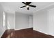 Bedroom features neutral walls, a ceiling fan and dark wood-look floors at 2651 Bennett Rd, Creedmoor, NC 27522