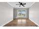 Empty bedroom features hardwood floors, ceiling fan, and natural light from the window at 2651 Bennett Rd, Creedmoor, NC 27522
