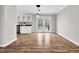 Bright dining area with new hardwood floors, modern lighting, and direct access to the backyard at 2651 Bennett Rd, Creedmoor, NC 27522