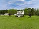 Charming white two-story home features a welcoming front porch and lush green yard at 2651 Bennett Rd, Creedmoor, NC 27522