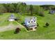 Aerial view of a two-story home with a large yard, outbuilding, and fencing on a beautiful property at 2651 Bennett Rd, Creedmoor, NC 27522