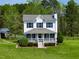 Charming two-story home with a welcoming front porch, lovely landscaping, and a well-maintained lawn at 2651 Bennett Rd, Creedmoor, NC 27522