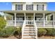 Inviting front porch with a wreath on the door, a cozy swing, and decorative lanterns and accessories at 2651 Bennett Rd, Creedmoor, NC 27522