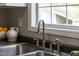 Kitchen area with stainless steel sink, goose neck faucet, white appliances and wood look floors at 2651 Bennett Rd, Creedmoor, NC 27522