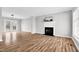 Bright living room featuring a fireplace, hardwood floors, and lots of natural light at 2651 Bennett Rd, Creedmoor, NC 27522