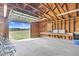 A spacious garage featuring plywood walls, a concrete floor and an open garage door to the yard at 2651 Bennett Rd, Creedmoor, NC 27522