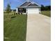Charming one-story home featuring a two-car garage, a green lawn, and minimal landscaping at 291 Deodora Ln, Cameron, NC 28326