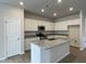 A well-lit kitchen features an island, white cabinets, granite countertops, and stainless steel appliances at 291 Deodora Ln, Cameron, NC 28326