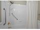 Bathroom featuring a tiled shower with safety bars and gold-toned fixtures at 30079 Britt, Chapel Hill, NC 27514