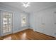 Bedroom featuring hardwood floors, a window, closet and a door at 30079 Britt, Chapel Hill, NC 27514