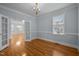 Bright bedroom with hardwood floors, chandelier lighting, and ample natural light at 30079 Britt, Chapel Hill, NC 27514