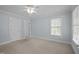 Bedroom featuring neutral colored carpet, a window and two doors at 30079 Britt, Chapel Hill, NC 27514