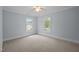 Bright bedroom with a ceiling fan and two large windows offering plenty of natural light at 30079 Britt, Chapel Hill, NC 27514