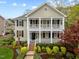 Charming two-story home featuring a double front porch and lush, colorful landscaping at 30079 Britt, Chapel Hill, NC 27514