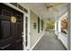 Inviting covered front porch with black front door and nautical decor, offering a relaxing outdoor space at 30079 Britt, Chapel Hill, NC 27514