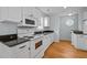 Efficient kitchen features white appliances, granite countertops, and hardwood floors for easy maintenance at 30079 Britt, Chapel Hill, NC 27514
