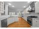 Bright kitchen with stainless steel appliances, white cabinets, and hardwood floors at 30079 Britt, Chapel Hill, NC 27514