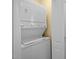 A stacked white washer and dryer are conveniently located behind a white door in this home at 30079 Britt, Chapel Hill, NC 27514