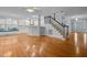 Open concept home with hardwood floors, staircase, and kitchen featuring white cabinets and window seat at 30079 Britt, Chapel Hill, NC 27514