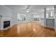 Bright open living room with fireplace, hardwood floors and kitchen featuring a window seat at 30079 Britt, Chapel Hill, NC 27514