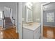 Cozy powder room with classic fixtures and a decorative mirror with easy access to the stairway at 30079 Britt, Chapel Hill, NC 27514