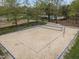 A bright community sand volleyball court with manicured landscaping and a swimming pool in the background at 30079 Britt, Chapel Hill, NC 27514