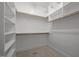Walk-in closet with multiple shelves, hanging rods, and carpet flooring for easy organization at 30079 Britt, Chapel Hill, NC 27514