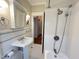 Bathroom featuring a shower, white subway tile, and pedestal sink at 306 Perry St, Raleigh, NC 27608
