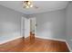 Bedroom boasts hardwood floors, ceiling fan, and white doors at 306 Perry St, Raleigh, NC 27608