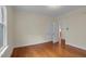 Bedroom with tan walls, hardwood floors, and white trim at 306 Perry St, Raleigh, NC 27608
