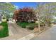 A long driveway leads to the detached garage; house is surrounded by lush greenery at 306 Perry St, Raleigh, NC 27608