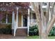Charming home exterior featuring a tree lined entry and welcoming porch at 306 Perry St, Raleigh, NC 27608